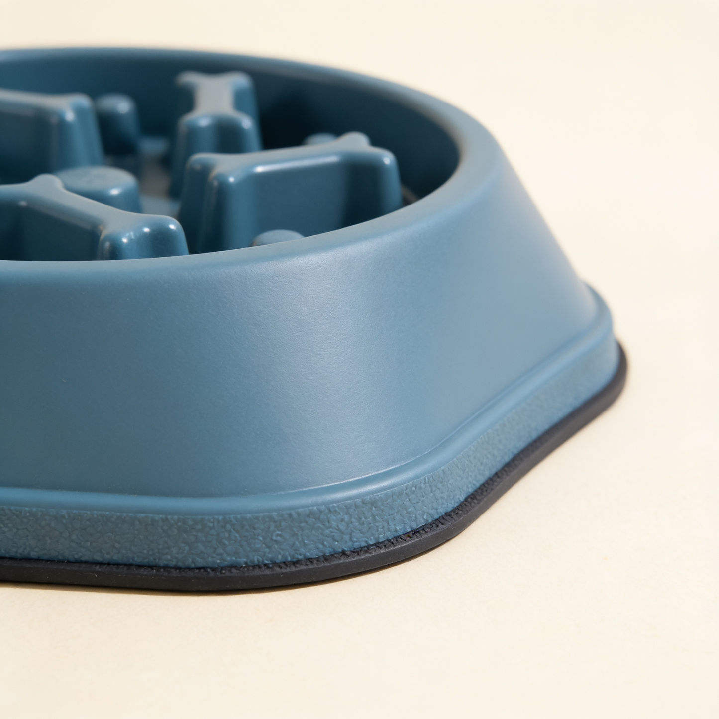 Close-up of the bone-shaped ridges and non-slip base of the Safe-Pace slow feeder bowl